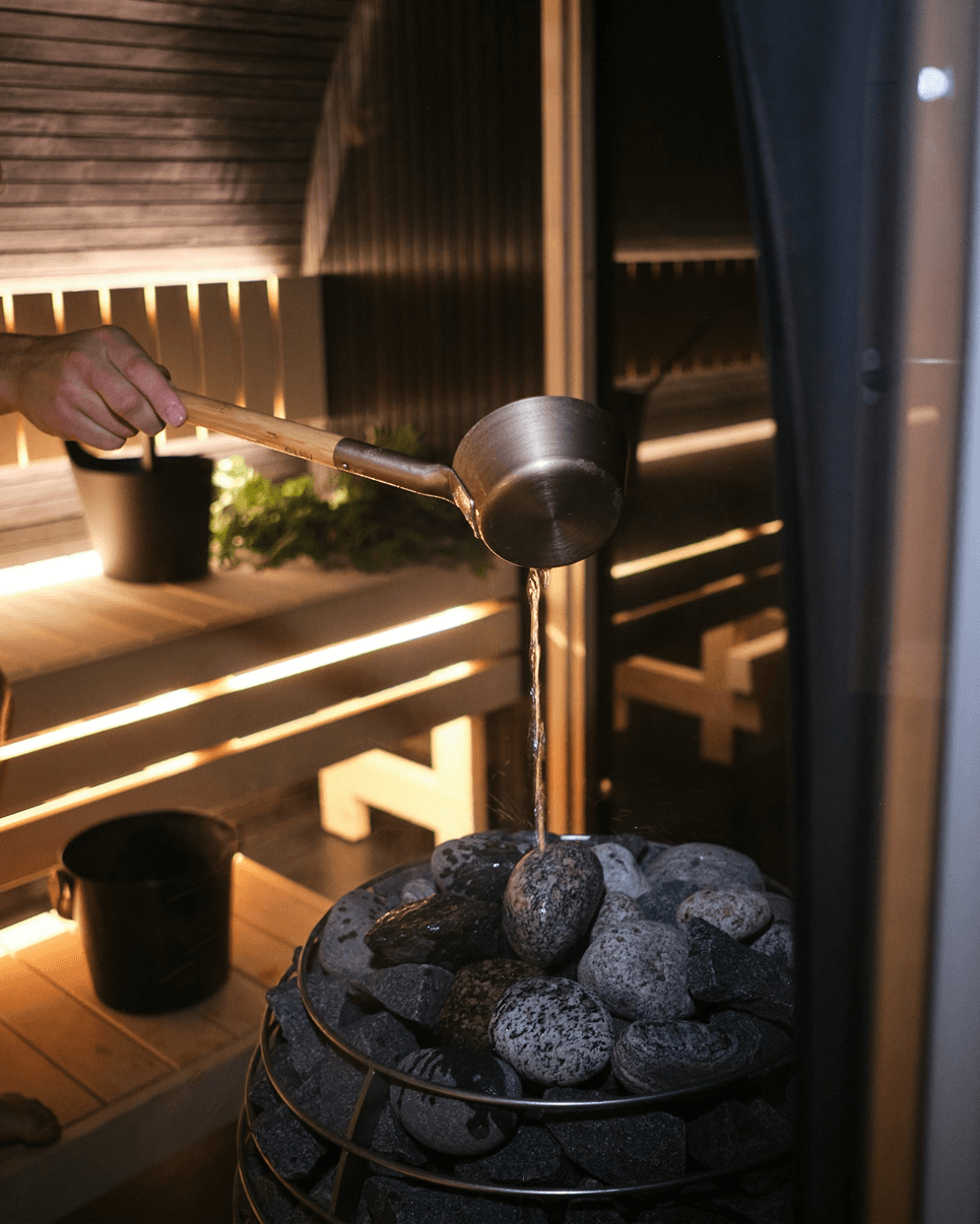 Water being ladled over hot stones in the Alpirious sauna