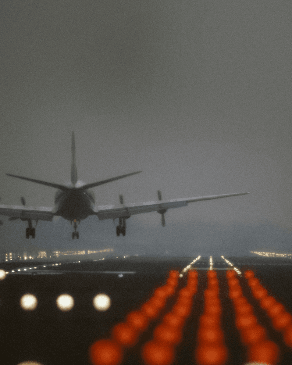 Airplane landing on a runway at night near the airport